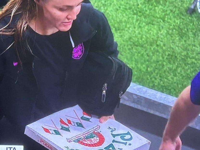 Woman holding a pizza box.
