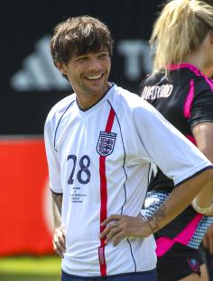 Louis Tomlinson in an England soccer jersey.