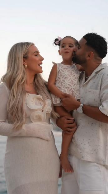 Family photo of a mother, father, and daughter.