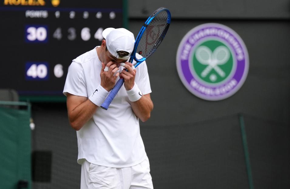 Tennis player Jack Draper at Wimbledon, holding his racket and looking dejected.