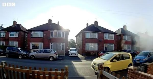 A terraced house exploding, sending shockwaves down the street.