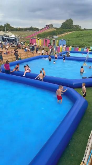 Children playing in inflatable pools at a National Forest Adventure Farm.