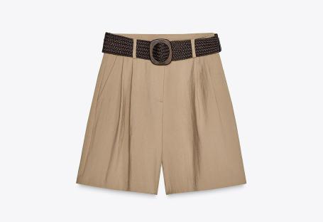 Beige shorts with a braided belt.
