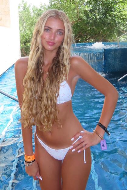 Princess Andre in a white bikini by a pool.
