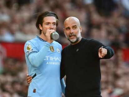 Pep Guardiola and Jack Grealish at a soccer match.