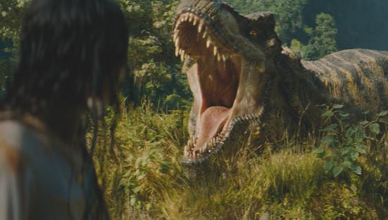 Luna Blaise in a scene from Jurassic World: Rebirth, facing a T-Rex.