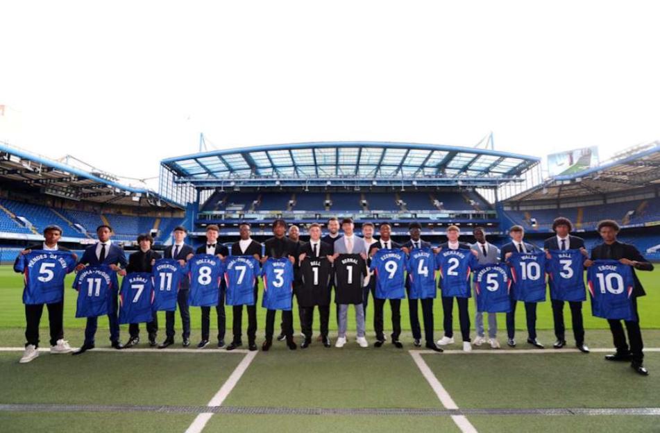 Chelsea academy signings holding their jerseys.