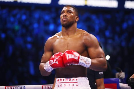 Anthony Joshua in boxing gloves before a heavyweight fight.