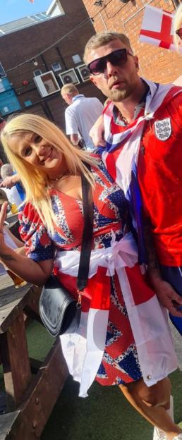 Woman in Union Jack dress with son, refused entry to pub.
