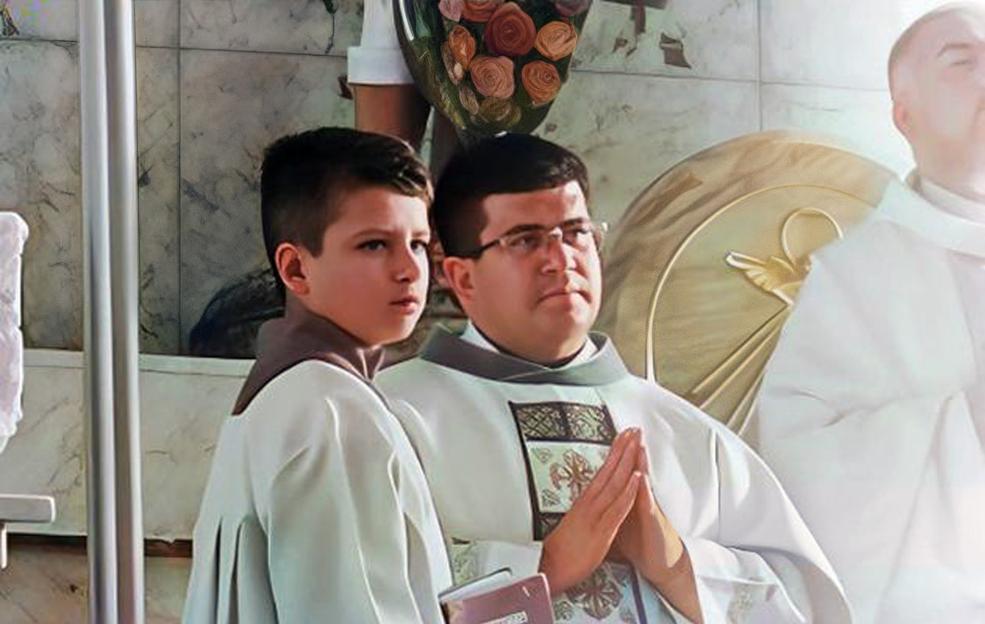 A priest and altar boy in white robes.