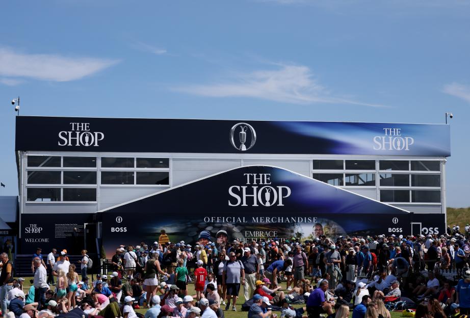 Golf fans queueing outside an official merchandise shop.