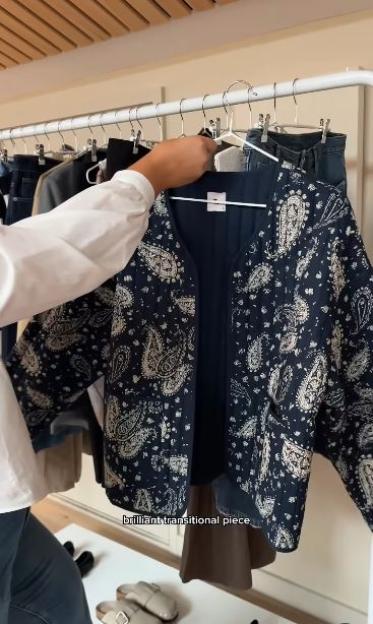 Paisley-patterned jacket on a clothing rack.