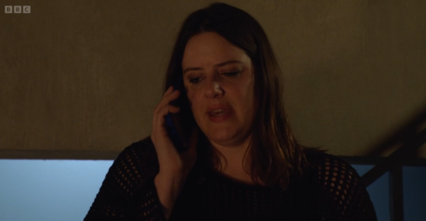 Screenshot of a woman on a phone call, appearing upset.