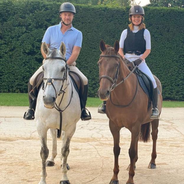 Two people horseback riding.