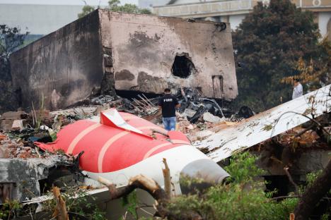 Wreckage of a burned Air India plane at a crash site.