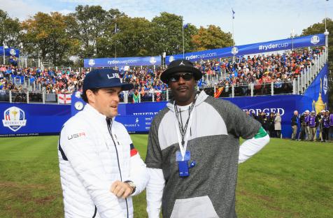 Keegan Bradley of the U.S. Ryder Cup team speaks with Michael Jordan.