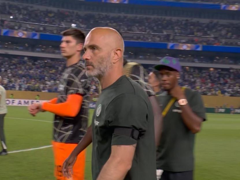 Chelsea manager and players on the pitch.