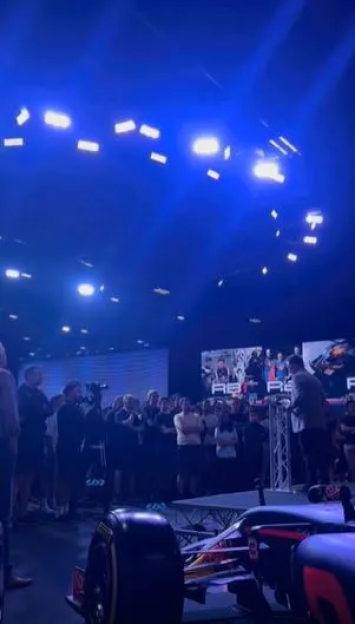 Formula 1 car presentation with audience.