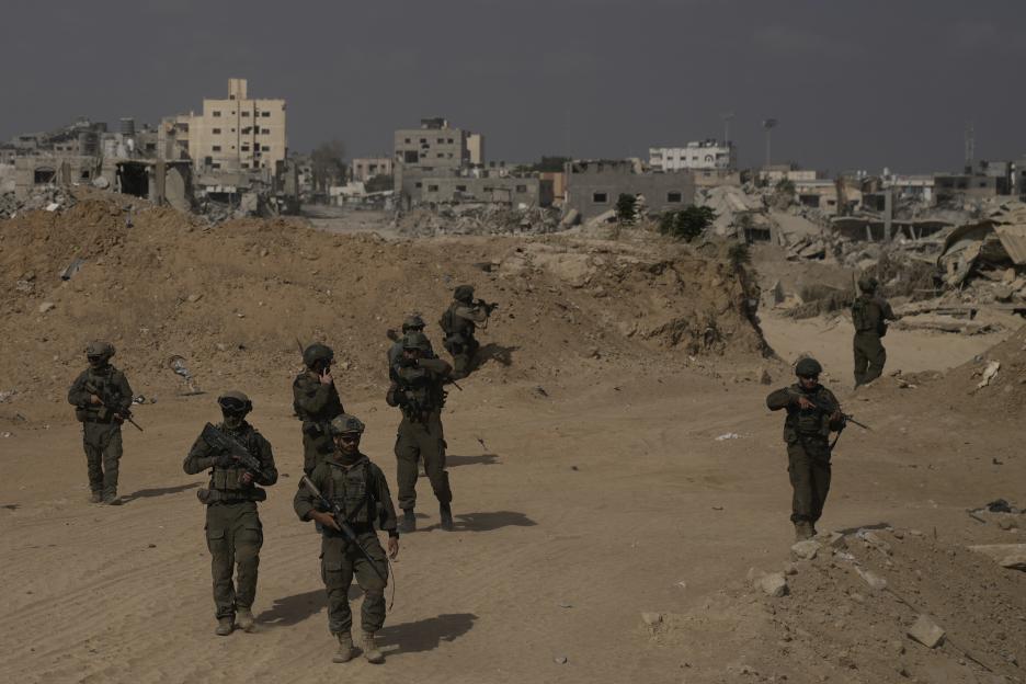 Israeli soldiers in a war-torn area.