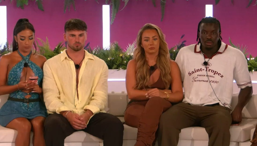 Screenshot of four people sitting on a couch.