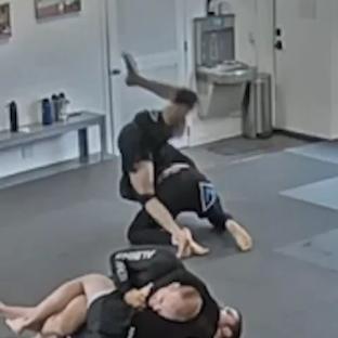 Jiu-jitsu students grappling on a mat.