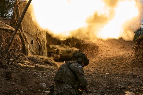 A soldier watches an M109 A3 gun fire near Kostiantynvka, Ukraine.