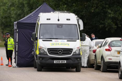 Police forensic officers at a crime scene.