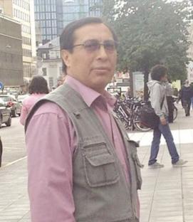 CCTV image of Fredi Rivero, wearing a pink shirt and grey vest.