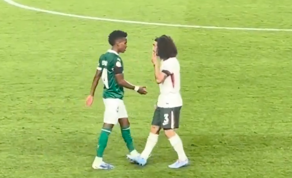 Two soccer players facing each other on a field.