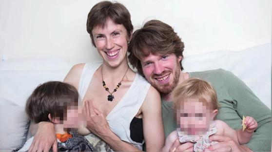 A woman breastfeeding a young child while her partner holds another child.