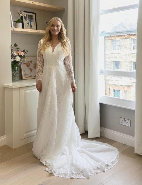 Woman in a long white lace wedding dress.