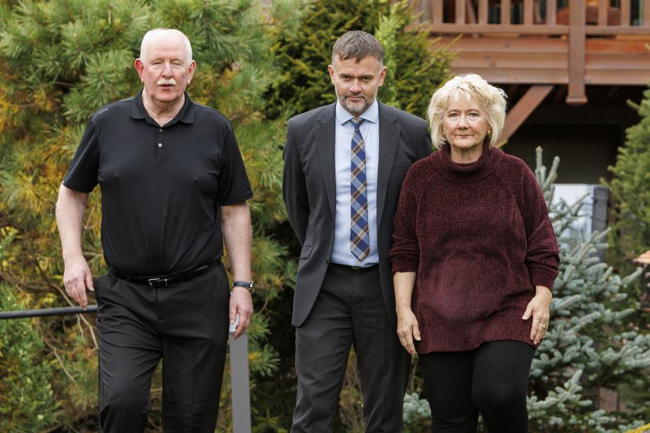 Alec McKay, his wife, and a detective stand together outside.