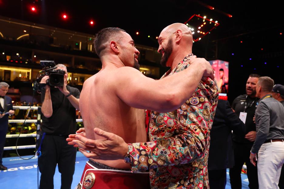 Joseph Parker and Tyson Fury embracing after a boxing match.