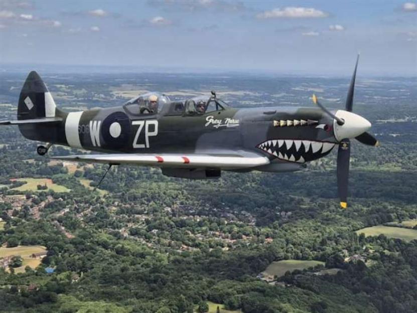 A man in a Spitfire airplane.