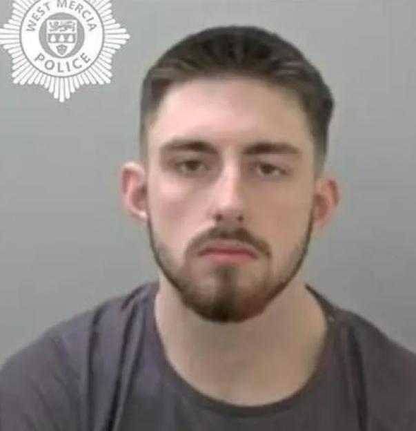 Mugshot of a man with a beard.