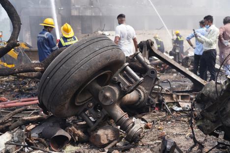 Debris from a plane crash, including a damaged wheel and landing gear.