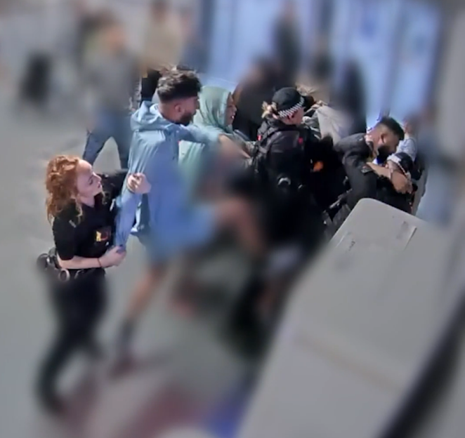 Police officers arresting a suspect at an airport.