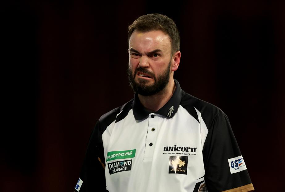 Ross Smith of England reacts during a darts match.