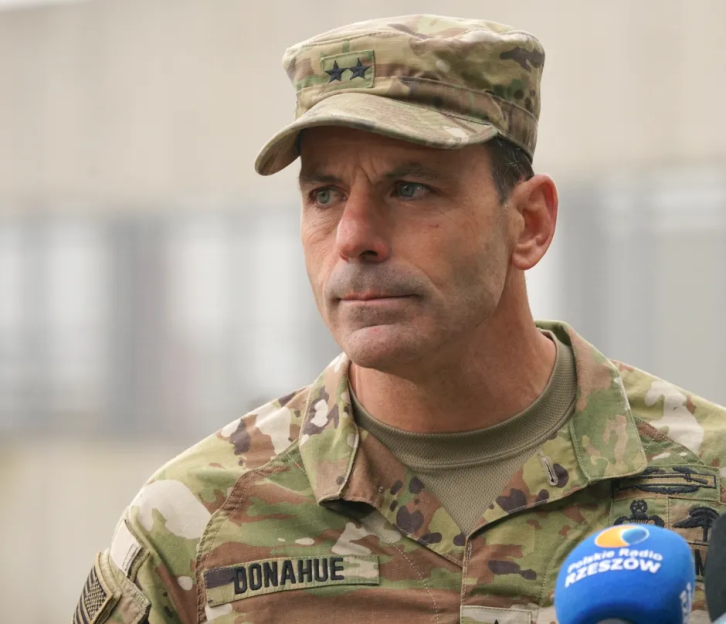 A military officer in camouflage uniform.