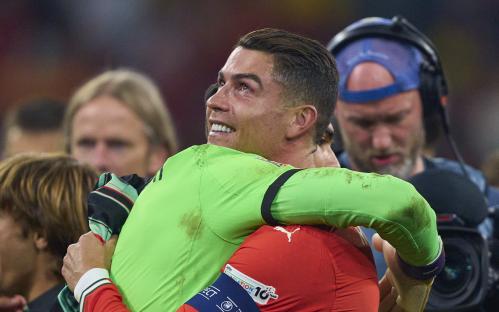 Cristiano Ronaldo and Diogo Costa celebrating a trophy win.