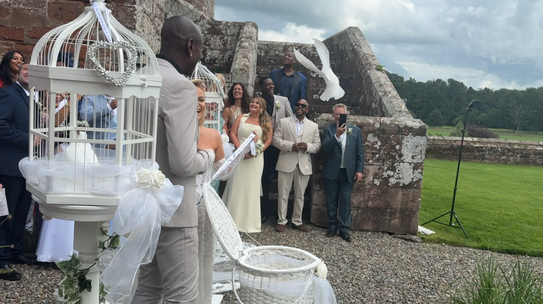 Wedding ceremony with white doves being released.