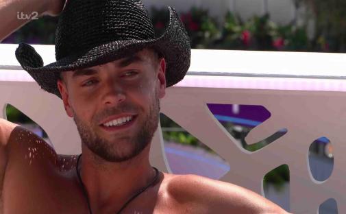 Man in cowboy hat smiling.