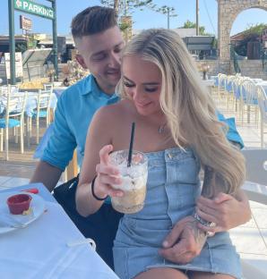 Couple sitting together at an outdoor restaurant.