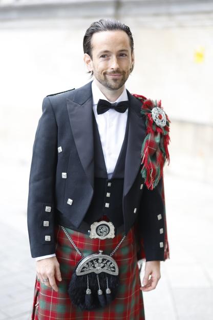 Man in kilt at wedding.