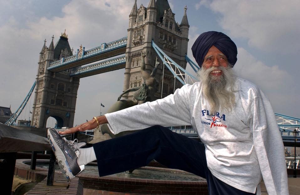 Fauja Singh, 91, stretching near Tower Bridge before the London Marathon.
