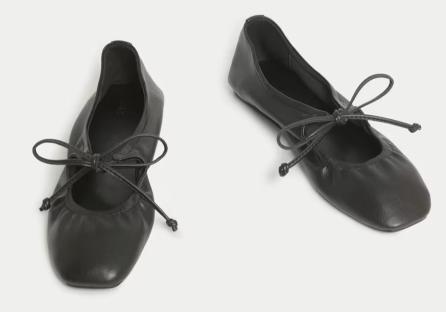 Pair of black ballet flats with laces.