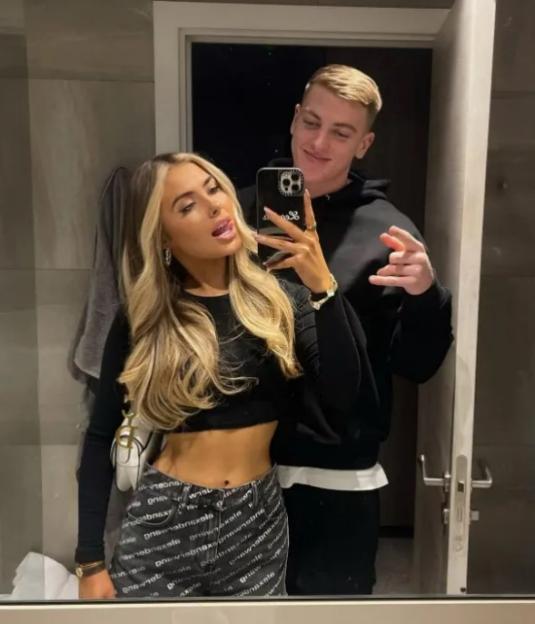 Selfie of a couple in a bathroom mirror.