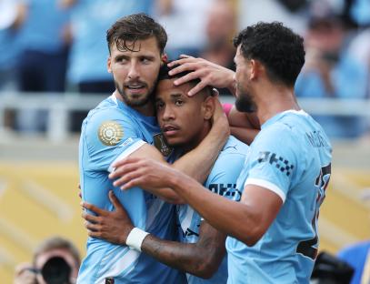 Manchester City players celebrating a goal.