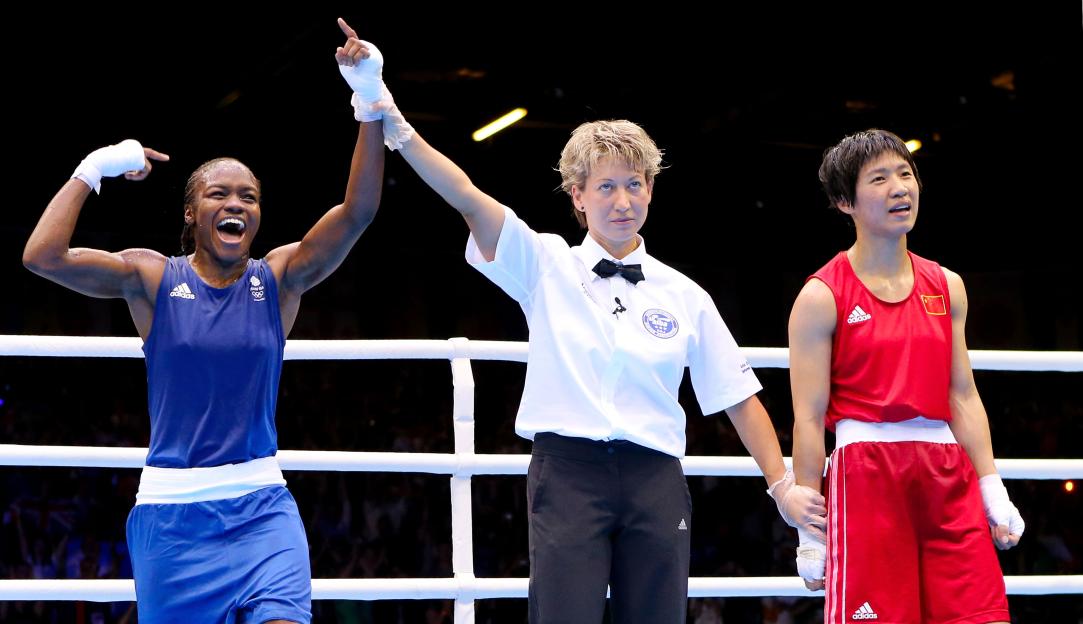 Referee announces Nicola Adams as the winner of a women's boxing match.