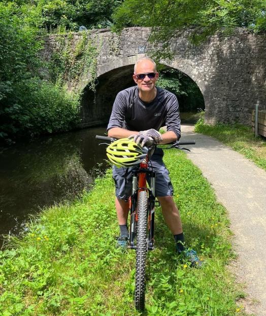Man with bike by canal.